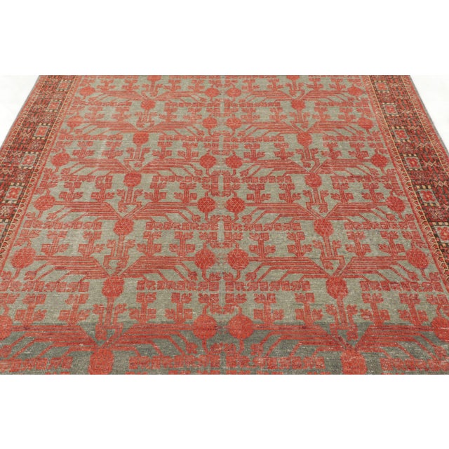 Hand-knotted in wool, this 6x12 antique Khotan runner dates to circa 1920–1930. The design features a repeating...