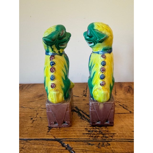 Charming Vintage Pair of Porcelain Chinese Foo Dogs Sitting on Boxes. They are small in stature but large in presence....