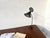 1950s diabolo desk lamp, reminiscent of Mathieu Matégot's perforated metal lighting fixtures. Two dark green lacquered...