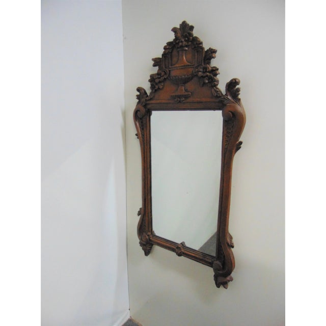 Italian style mirror , early 1900’s , hand carved pine frame with urn and floral bouquet crest