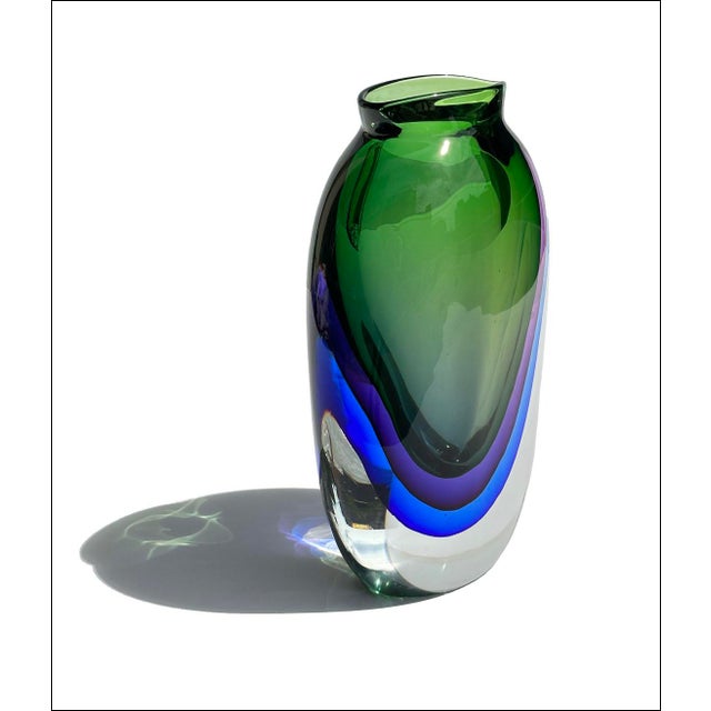 Iconic piece of Italian glass from Murano. Exact age and maker not known. Gorgeous handmade vase of flattened form and...