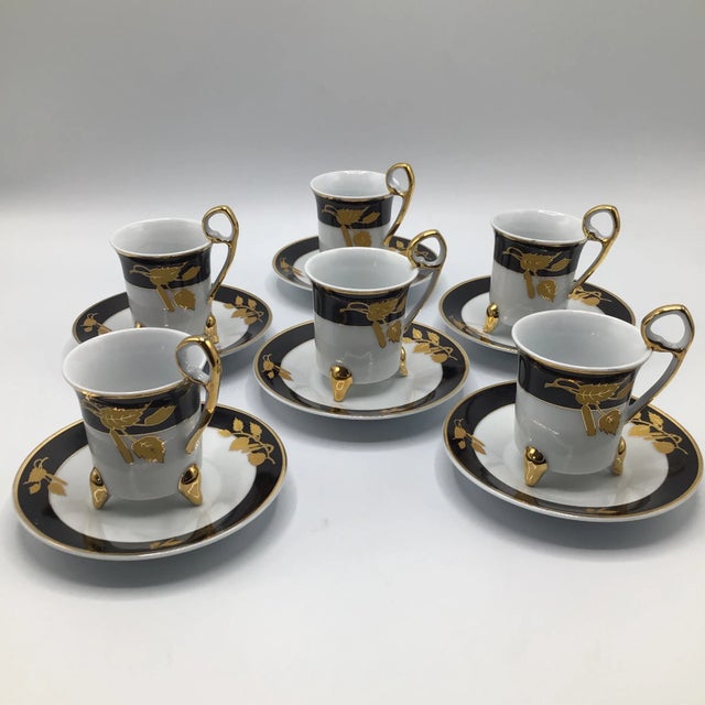 Here is a 12 piece vintage fine porcelain Demitasse teacup set with original decorative box. Six cups and six saucers. The...