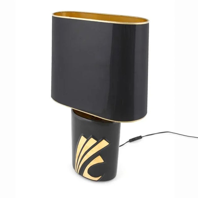 Pair of black-enamelled porcelain table lamps from the EVE Collection. Handcrafted and gold-plated with an original...