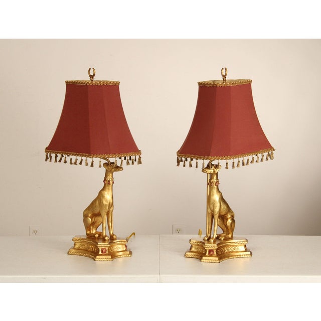 High Quality Pair Of Egyptian Revival Table Lamps Featuring Seated Greyhound Figures With Gilt Finish Mounted On...