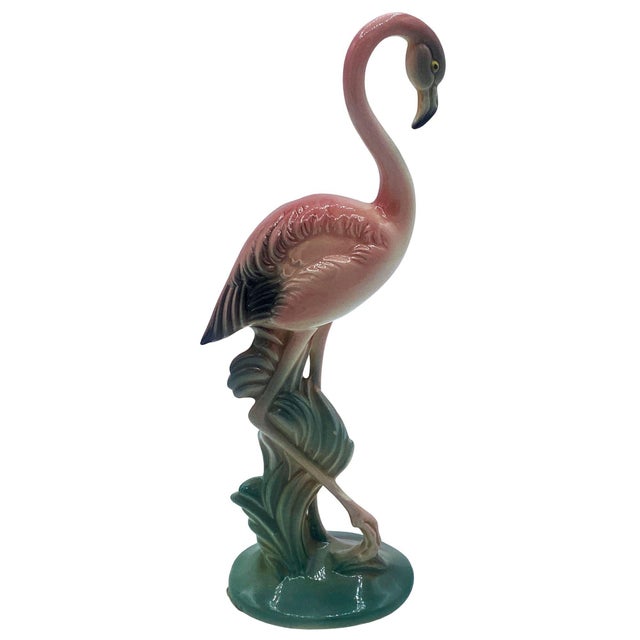 Mid-century pink and green matching California ceramic flamingo tabletop statues with the short statue by Brad Keeler. The...