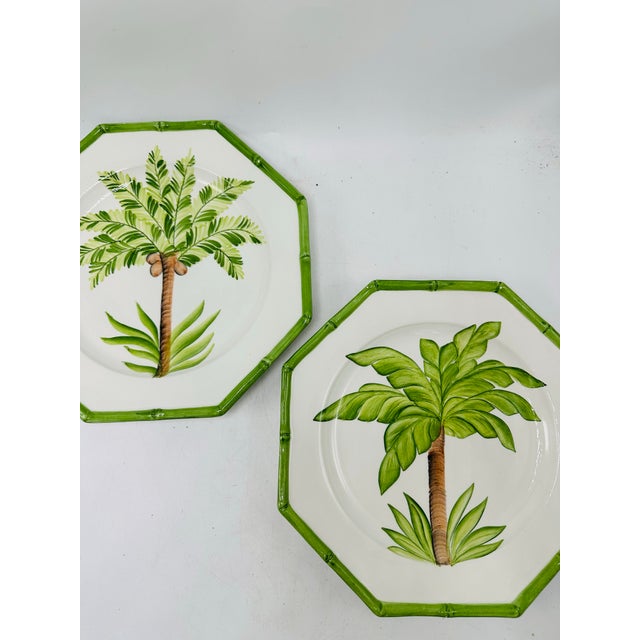 A pair of hand-painted Italian ceramic plates by TanSai featuring tropical palm tree motifs. Each octagonal plate has a...