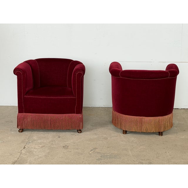 Danish pair of club chairs in burgundy velvet, likely by a Danish Cabinetmaker, 1950s. Each chair has a gently channelled,...