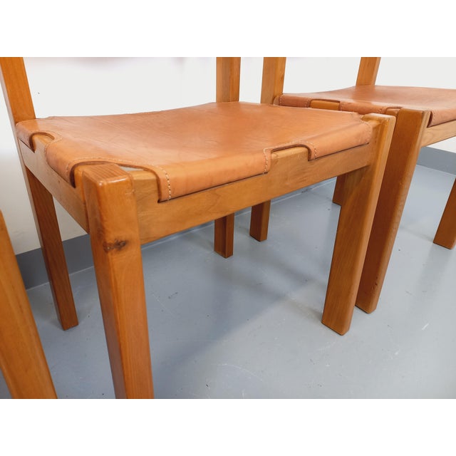 Four vintage chairs from Maison Regain, from the 1970s and 1980s. Frame and backrests are made of solid blond elm, and...