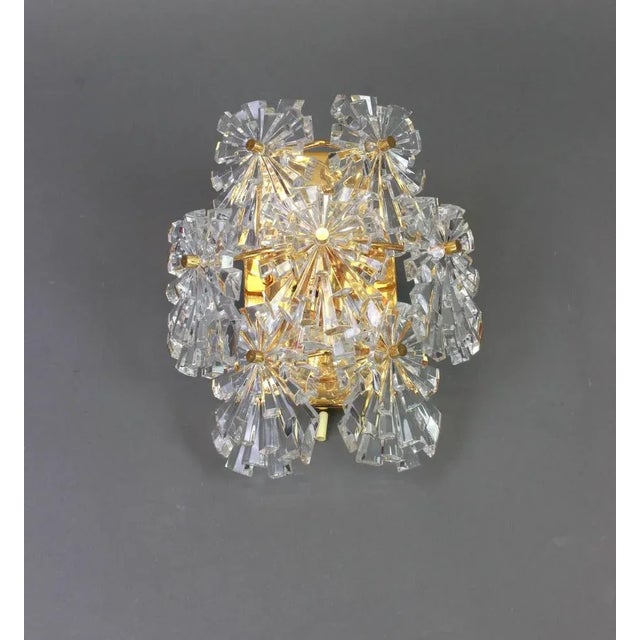 A stunning pair of golden sconces with crystal glasses, made by kinkeldey, germany, circa 1970-1979. It’s composed of...