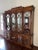 Gorgeous and grand Chinese Chippendale Chinoiserie Style lighted china cabinet featuring a carved pagoda top, mirrored,...