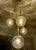 Mid-Century multi-layer by Doria, cascade style chandelier, pendant light with 4 individual lights with amber color molten...