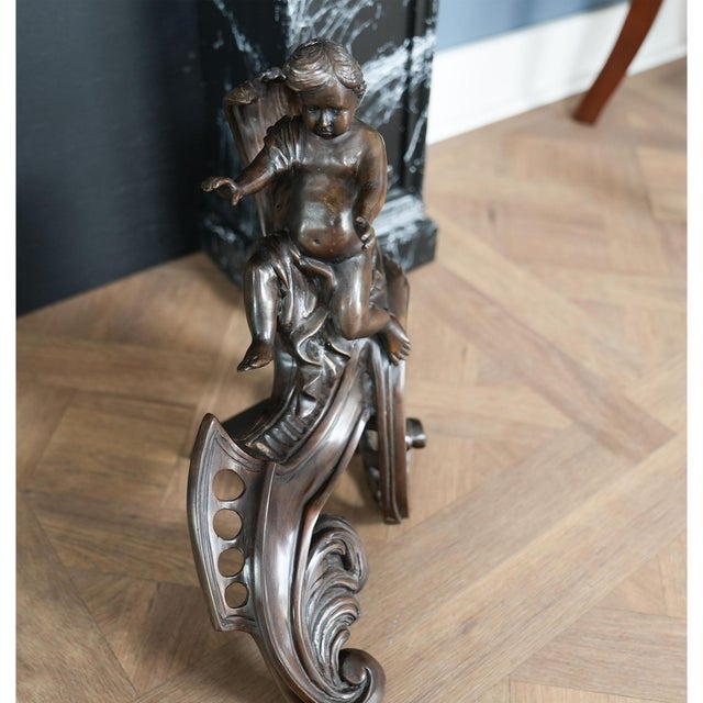From Niagara Furniture a pair of the finest quality, French style bronze andirons. Completely hand cast using traditional...