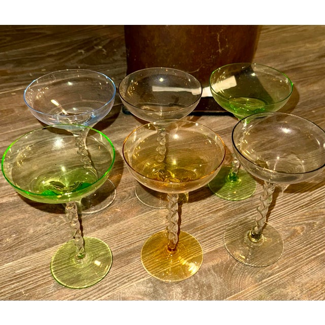 6 antique coupe glasses of various colors with twisted stem. Originally styled as a champagne glass, also used for...