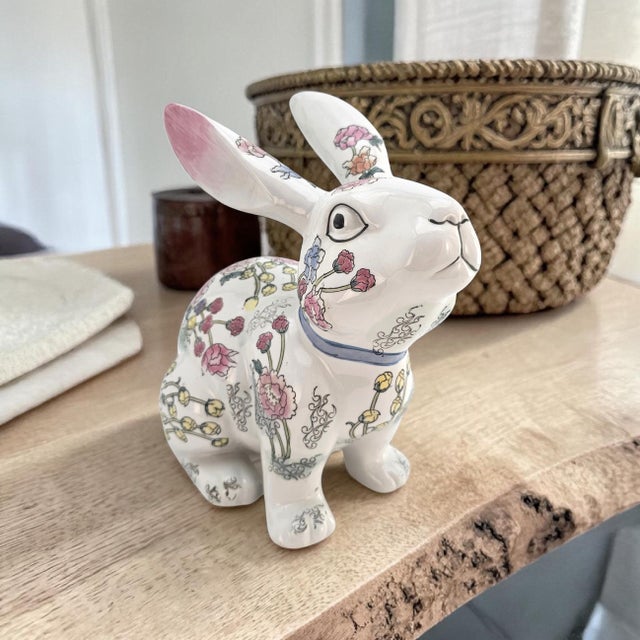 A large hand-painted porcelain rabbit, decorated in a charming all-over floral motif that evokes the delicate decorative...