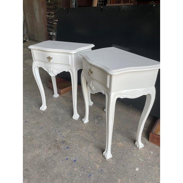 Elegant pair of white lacquered bedside tables in the Dom João V style, inspired by Portuguese Baroque and Rococo...