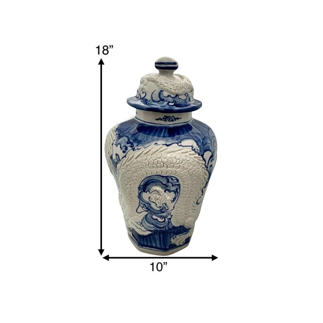 This vintage ginger jar features intricate 3D dragon designs in blue and white porcelain, reflecting traditional Chinese...