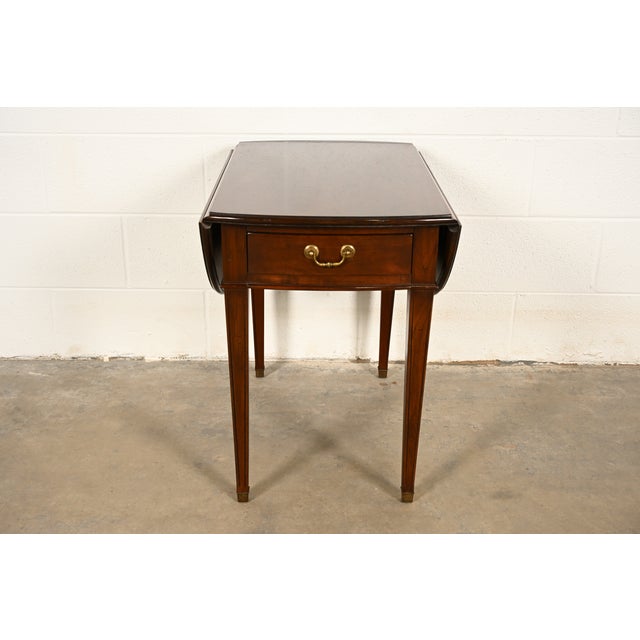 A gorgeous Georgian or Regency style Pembroke nightstand, tea table, or side table By Ethan Allen USA, Circa 1970s Cherry...