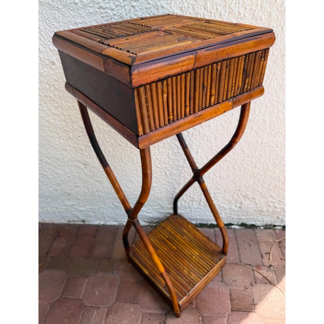 Vintage bamboo and rattan plant stand features a unique burnt finish and a small drawer can also be used as a side table