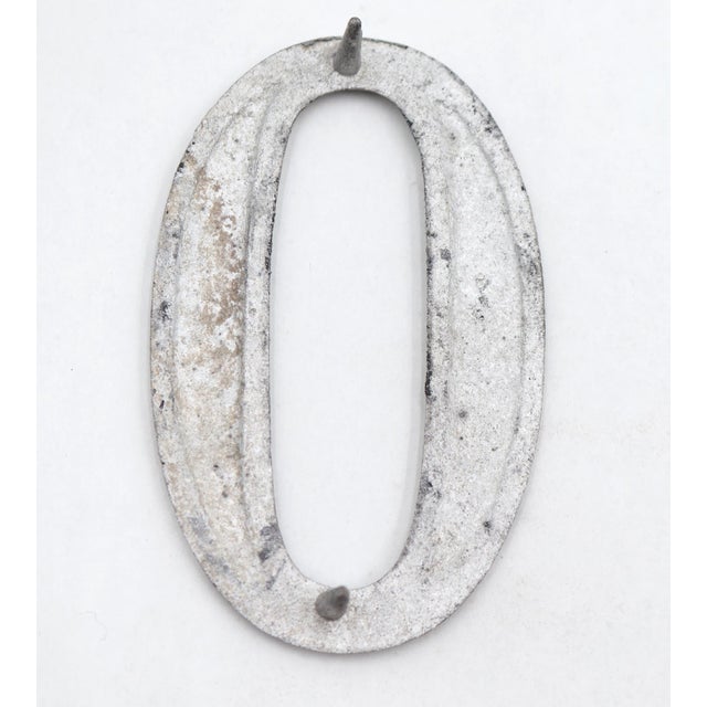 Vintage brushed aluminum numeral 0 outdoor house or building marker with two prongs on the back. Good condition with...