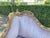 An elegant 1950s French Louis XVI-style corner sofa, crafted with a hand-carved solid beechwood frame, an antique gold...