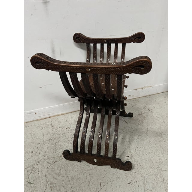 Syrian "curule" style armchair in carved wood with inlay Folding armchair with mother-of-pearl inlay Minor losses, see...