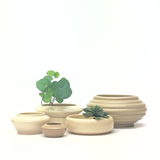 Neutral white ceramic planters, group of 5. This set of minimalist mid-century planters is in a neutral colorway,...