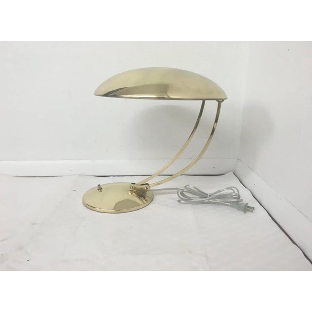 This is an adjustable brass desk lamp. It has been rewired and polished. It is in good condition.
