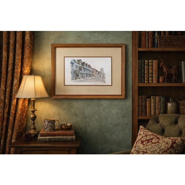 This vintage watercolor depicts a charming English street scene featuring the Shakespeare Hotel and the Guild Chapel,...