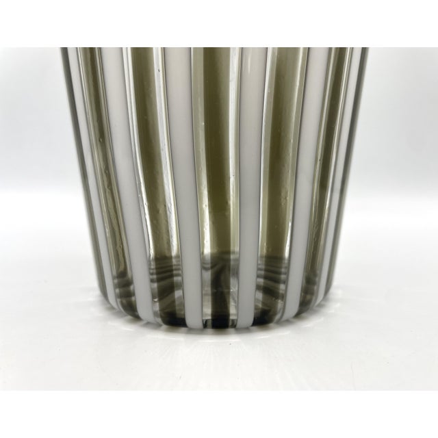 A white and smoky reed vase designed by Gio Ponti and made by the Venini glassworks. The reed vase is particularly...