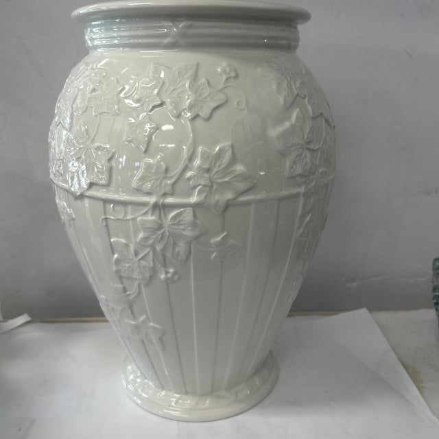 Beautiful earthenware vase by Wedgwood features a fluted design with ivy detail. A classic piece that will enhance any...