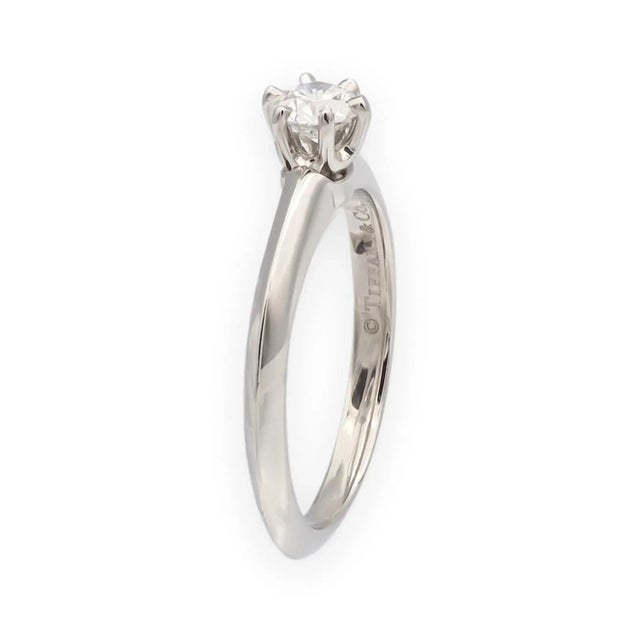 Classic Tiffany & Co. six-prong solitaire in platinum, set with a 0.24 carat round brilliant diamond graded D color and...