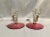A pair of Art Deco era double candle holders with cranberry flash bases. 6.75” w x 6” deep x 6” h, bases 6” diameter.