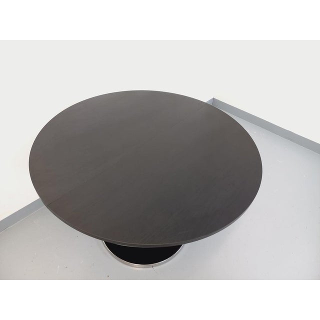 Vintage 1970s round dining table, Space Age or American diner style, with a round top and central pedestal base in black...