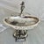 The Wilcox Silver Plate serving dish features a finely detailed angel and winged figure adornments along with acanthus...