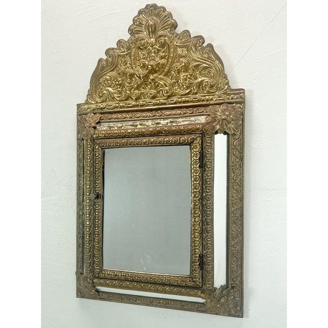 Very pretty and decorative Brass Cushion Mirror Cabinet, circa 1950's, inspired by the Antique Brass Repousse Dutch...