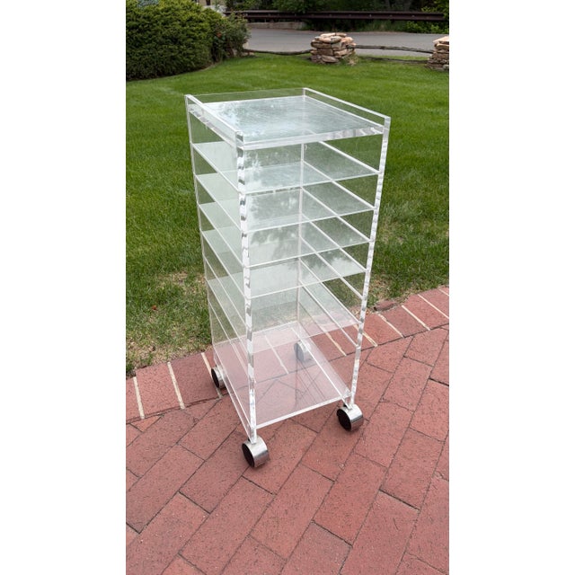 Akko Clear Acrylic Rolling Storage Cart A sleek and highly functional clear acrylic rolling cart by Akko, embodying the...