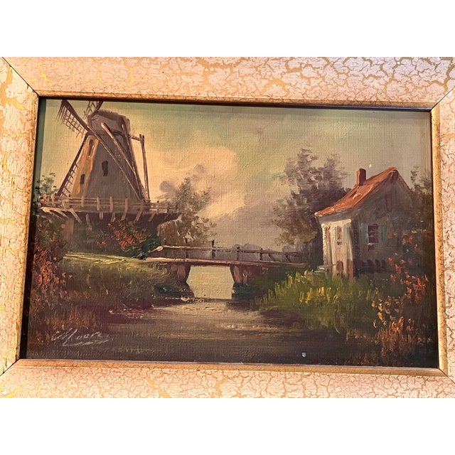Charming vintage oil on canvas depicting a picturesque Dutch canal landscape, featuring a traditional windmill overlooking...