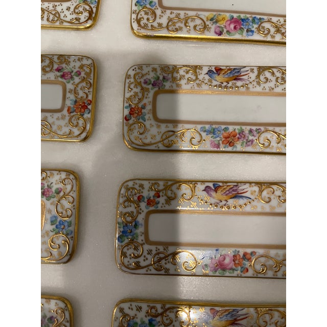 Pretty set of 8 Dresden decorated porcelain place card holders. Each is decorated with gold, pink, and blue flowers and a...