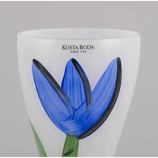 Ulrica Hydman Vallien for Kosta Boda, Sweden. Tall and slender vase with hand-painted floral motif. Late 20th century....