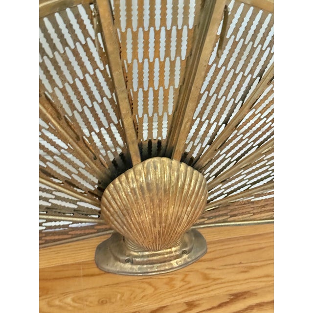 Vintage brass peacock fireplace screen with shell motif. Folds up for easy storage. Circa 1970s. Please see condition...