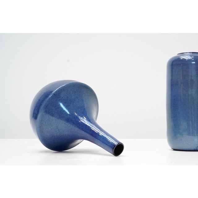 A refined ceramic vase by Belgian ceramist Roger Vandeweghe, known for his elegant forms and distinctive glaze work. This...