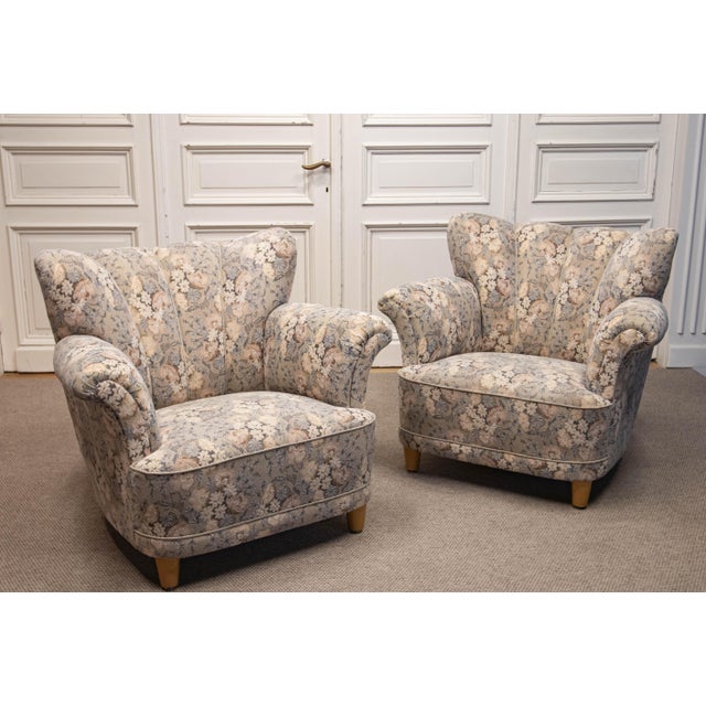 Elegant 1940s Danish lounge chairs, combining generous proportions with a softly sculpted silhouette and exceptional...