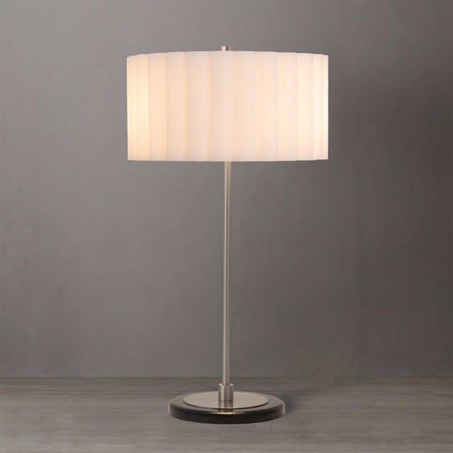 Featuring a sleek satin nickel steel body and a white linen drum shade, the Slimline Table Lamp is a modern table lamp...
