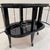 A Modernist ebonized bar cart. Black lacquer with polished nickel details, glass top with mirrored outer border and glass...