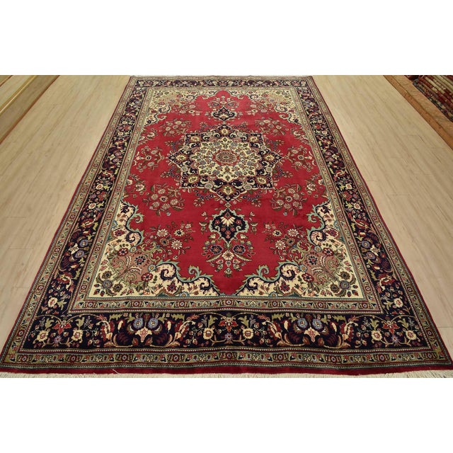 An authentic vintage traditional Tabriz rug hand-knotted with fine wool and natural dyes. This rug features a central...
