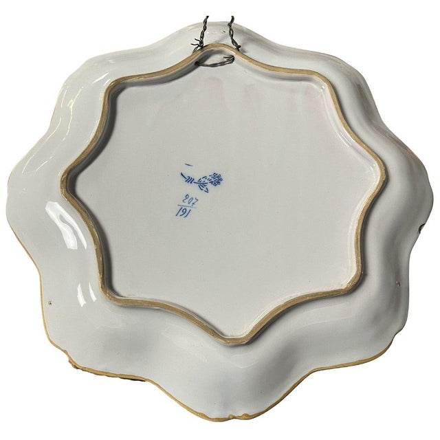Large polylobed earthenware dish from the Charolles factory, early 20th century, decorated with cherubs. The factory was...