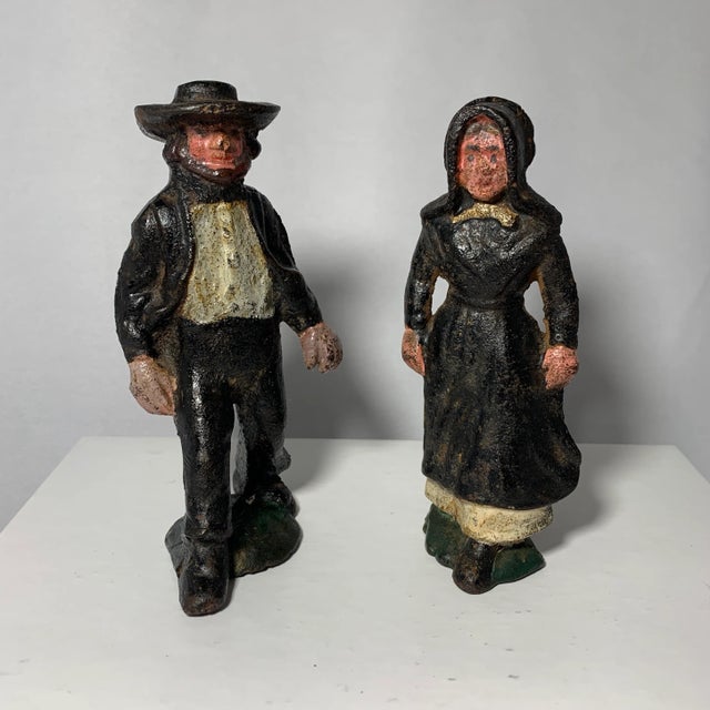 Heavy cast iron country folk figurines good for paperweights or desk display.