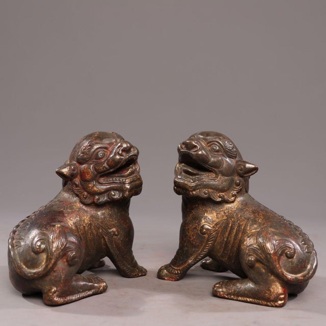This is a matched pair of antique gilt bronze sculptures depicting Pixiu, mythical creatures revered in traditional Asian...