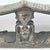 A carved double headrest from the Songye people is a sculptural sleeping support traditionally used in the savanna regions...