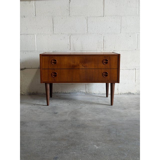 Beautiful vintage Danish Modern small dresser crafted in teak, featuring clean Scandinavian lines, sculptural recessed...
